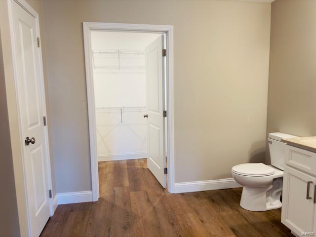 bathroom featuring hardwood / wood-style floors, toilet, and vanity