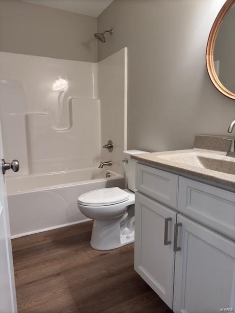 full bathroom featuring shower / bath combination, hardwood / wood-style floors, toilet, and vanity