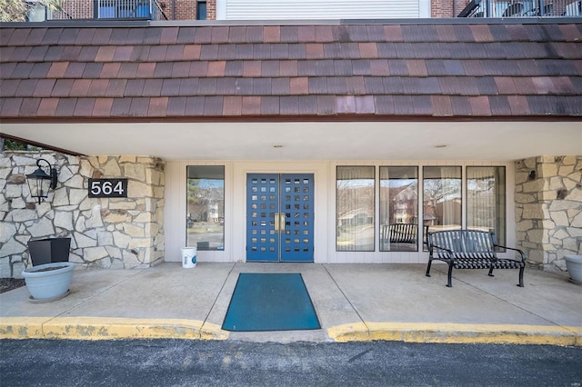 doorway to property with stone siding