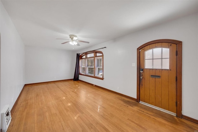 foyer entrance with ceiling fan and light hardwood / wood-style flooring