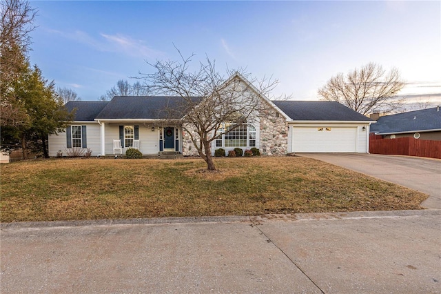 ranch-style house with a garage and a lawn