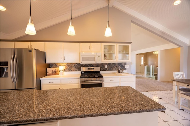 kitchen featuring hanging light fixtures, appliances with stainless steel finishes, backsplash, and beam ceiling