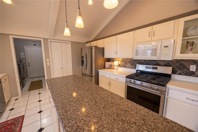 kitchen with vaulted ceiling, pendant lighting, tasteful backsplash, white cabinetry, and stainless steel appliances