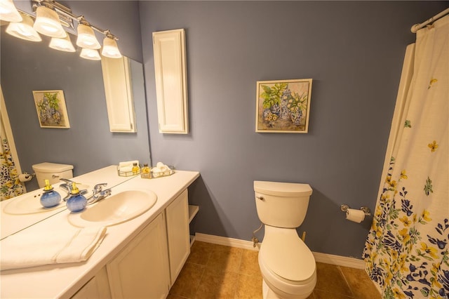 bathroom with tile patterned flooring, vanity, and toilet