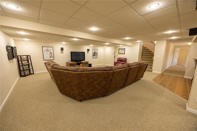 living room featuring light carpet and a drop ceiling