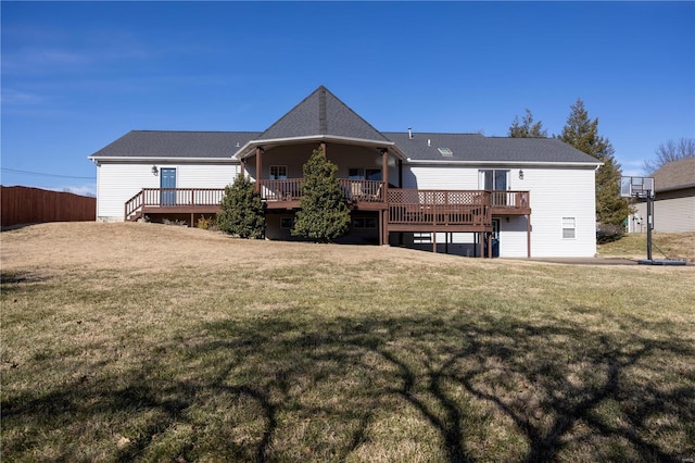 rear view of house with a lawn and a deck