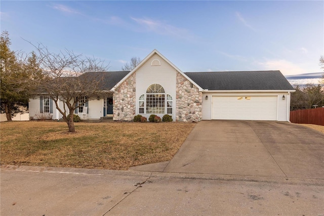 ranch-style home with a garage and a yard