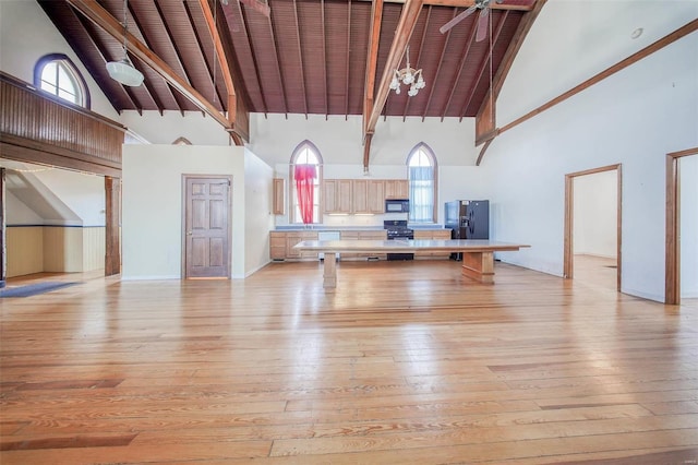 interior space featuring a healthy amount of sunlight, high vaulted ceiling, and light hardwood / wood-style floors