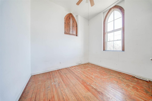 empty room with ceiling fan and wood-type flooring