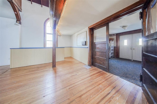 interior space with light hardwood / wood-style floors and a wealth of natural light