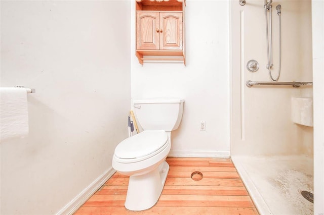 bathroom featuring hardwood / wood-style floors and toilet