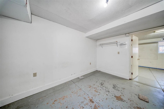 basement featuring a textured ceiling