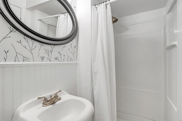 bathroom featuring sink and curtained shower