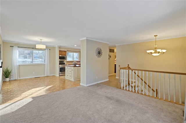 unfurnished living room featuring crown molding, light colored carpet, and an inviting chandelier