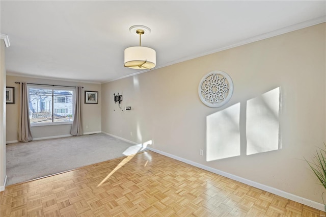 empty room with light parquet floors and crown molding