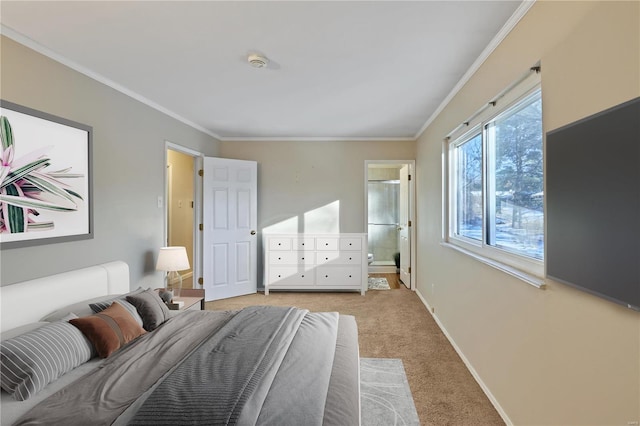 bedroom with ornamental molding, connected bathroom, and light carpet