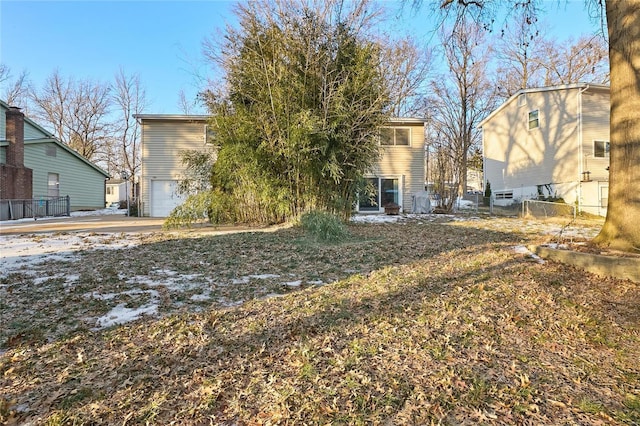 rear view of property with a garage