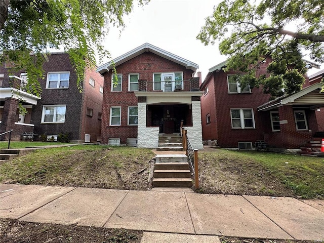 view of front of home featuring central AC unit and a balcony