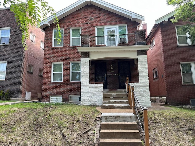 view of front of property featuring central AC and a balcony