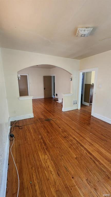 unfurnished living room featuring hardwood / wood-style floors