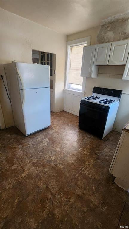 kitchen with range with gas cooktop, white cabinets, and white refrigerator