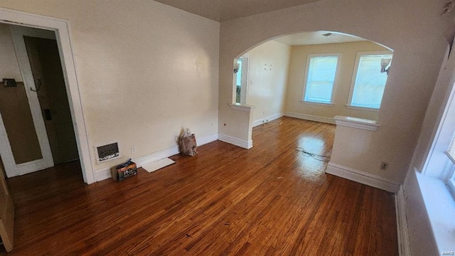 unfurnished living room with dark wood-type flooring