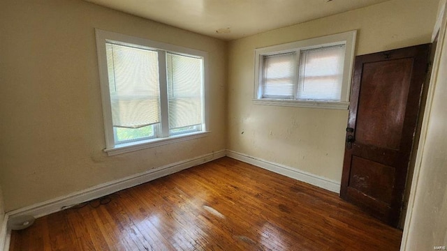 empty room with hardwood / wood-style floors