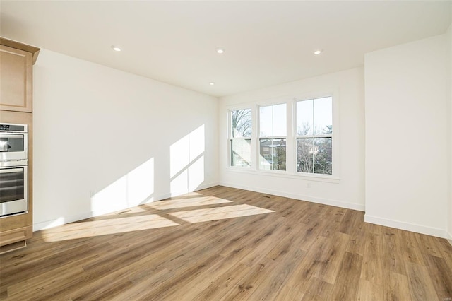 unfurnished living room with light hardwood / wood-style flooring