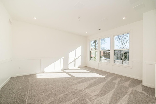 unfurnished room featuring light carpet