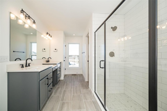 bathroom featuring vanity and a shower with shower door