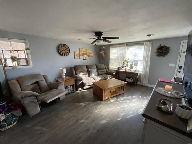 living room with ceiling fan and dark hardwood / wood-style flooring