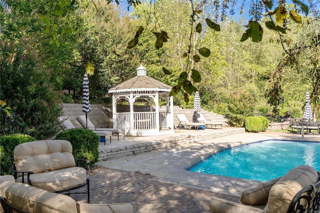 view of swimming pool with a gazebo and a patio