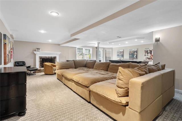 carpeted living room with crown molding, a fireplace, and decorative columns