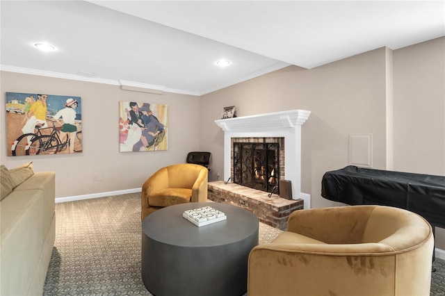 sitting room with a brick fireplace, carpet, and ornamental molding