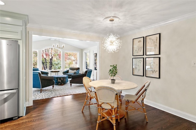 dining room with dark hardwood / wood-style floors, ornamental molding, lofted ceiling, and an inviting chandelier