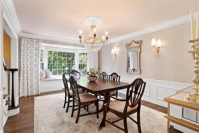 dining area with ornamental molding, dark hardwood / wood-style floors, and a notable chandelier