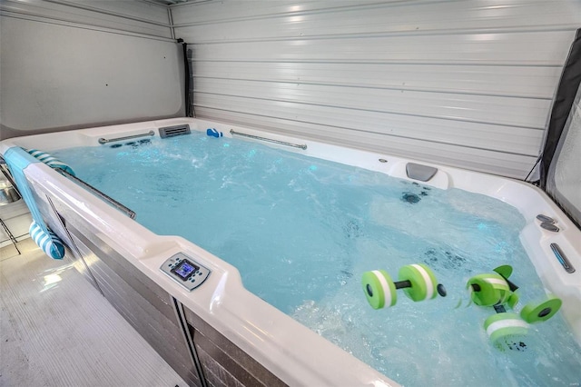 view of pool with a covered hot tub