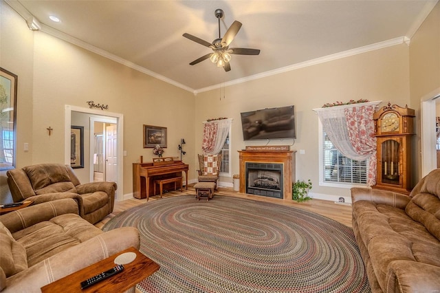 living room with wood-type flooring, ornamental molding, and ceiling fan