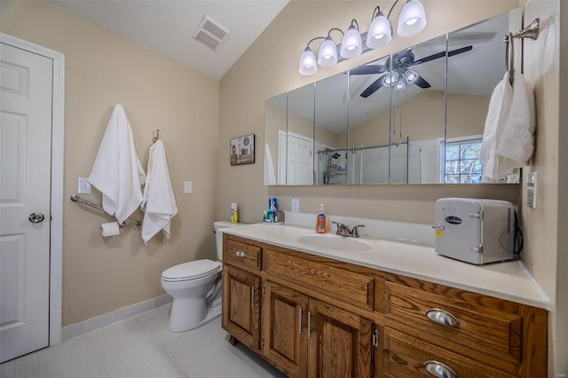 bathroom with ceiling fan, vanity, toilet, and vaulted ceiling