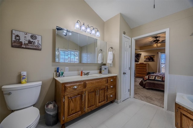 bathroom featuring lofted ceiling, vanity, and toilet