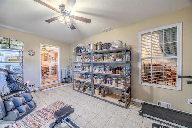 interior space featuring light tile patterned floors and ceiling fan