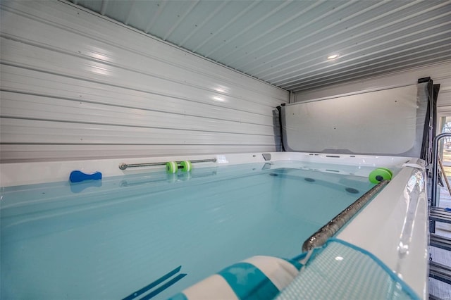 view of pool with a covered hot tub