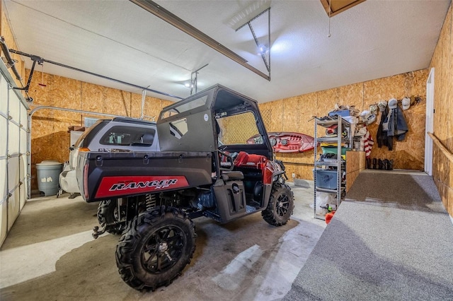 garage featuring wood walls