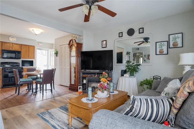 living room with light wood-type flooring and tile walls