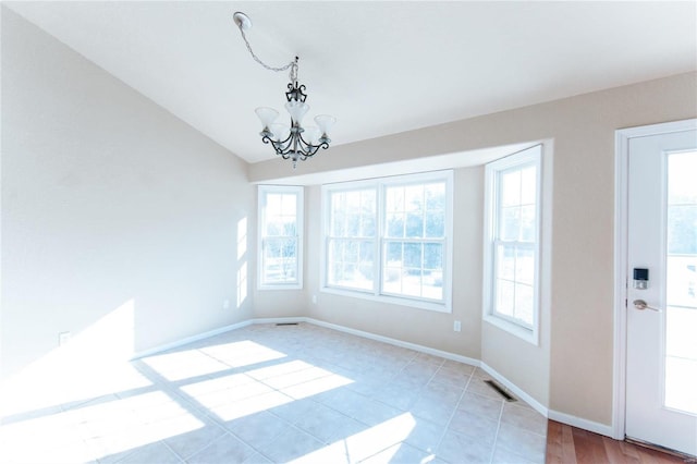 unfurnished dining area featuring lofted ceiling and an inviting chandelier