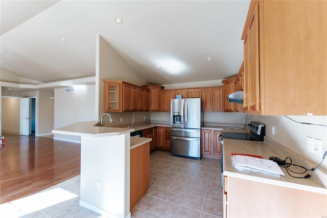 kitchen with stainless steel appliances, lofted ceiling, and light tile patterned floors