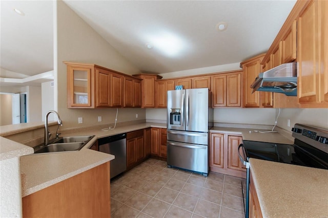 kitchen with lofted ceiling, sink, light tile patterned floors, kitchen peninsula, and stainless steel appliances