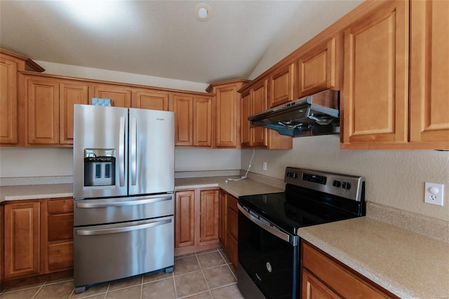 kitchen featuring lofted ceiling, light tile patterned flooring, and appliances with stainless steel finishes