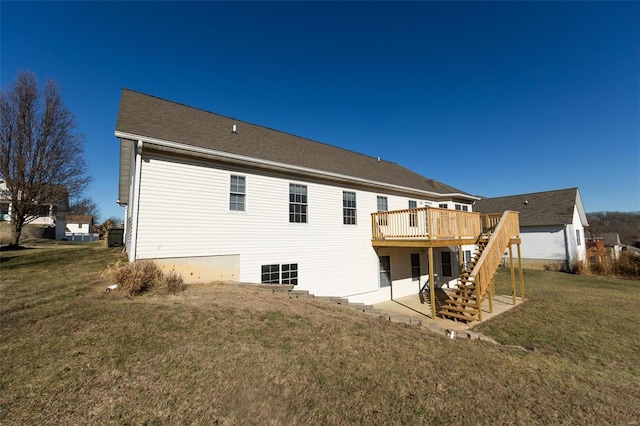 rear view of house featuring a wooden deck and a yard