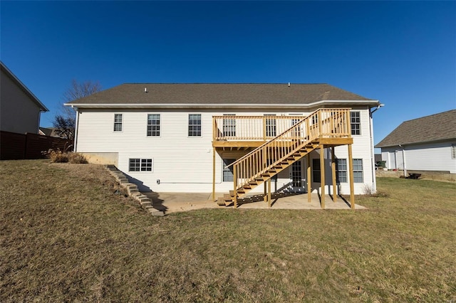 back of property with a wooden deck, a lawn, and a patio